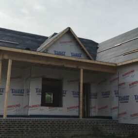 Pictured is an unfinished residential home wrapped in Talbert Logo'd underlayment
