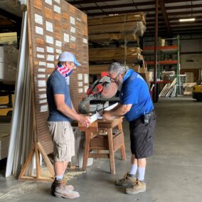 Pictured is a Durham Team member assisting a customer by cutting some material.